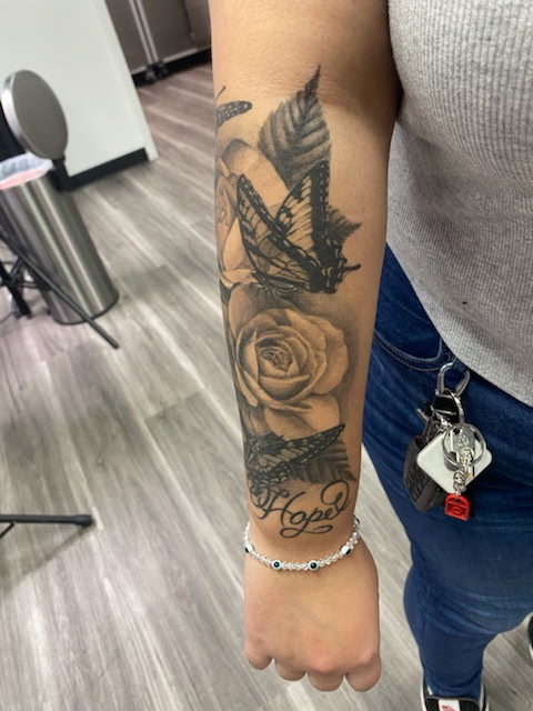 Black and grey butterfly rose and hope forearm tattoo at Darkstar Tattoo Riverside CA