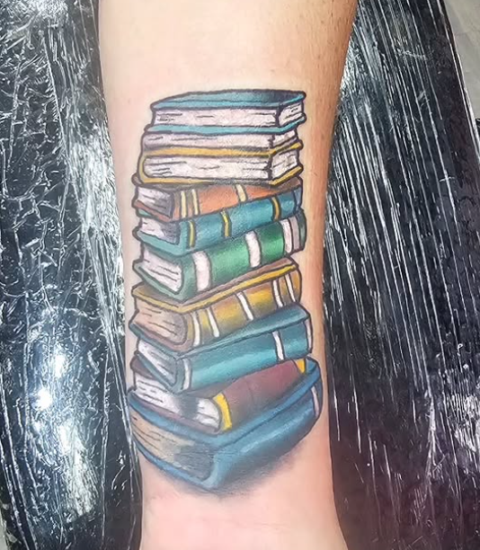 Color stack of books tattoo by Kevin at Darkstar Tattoo Riverside CA