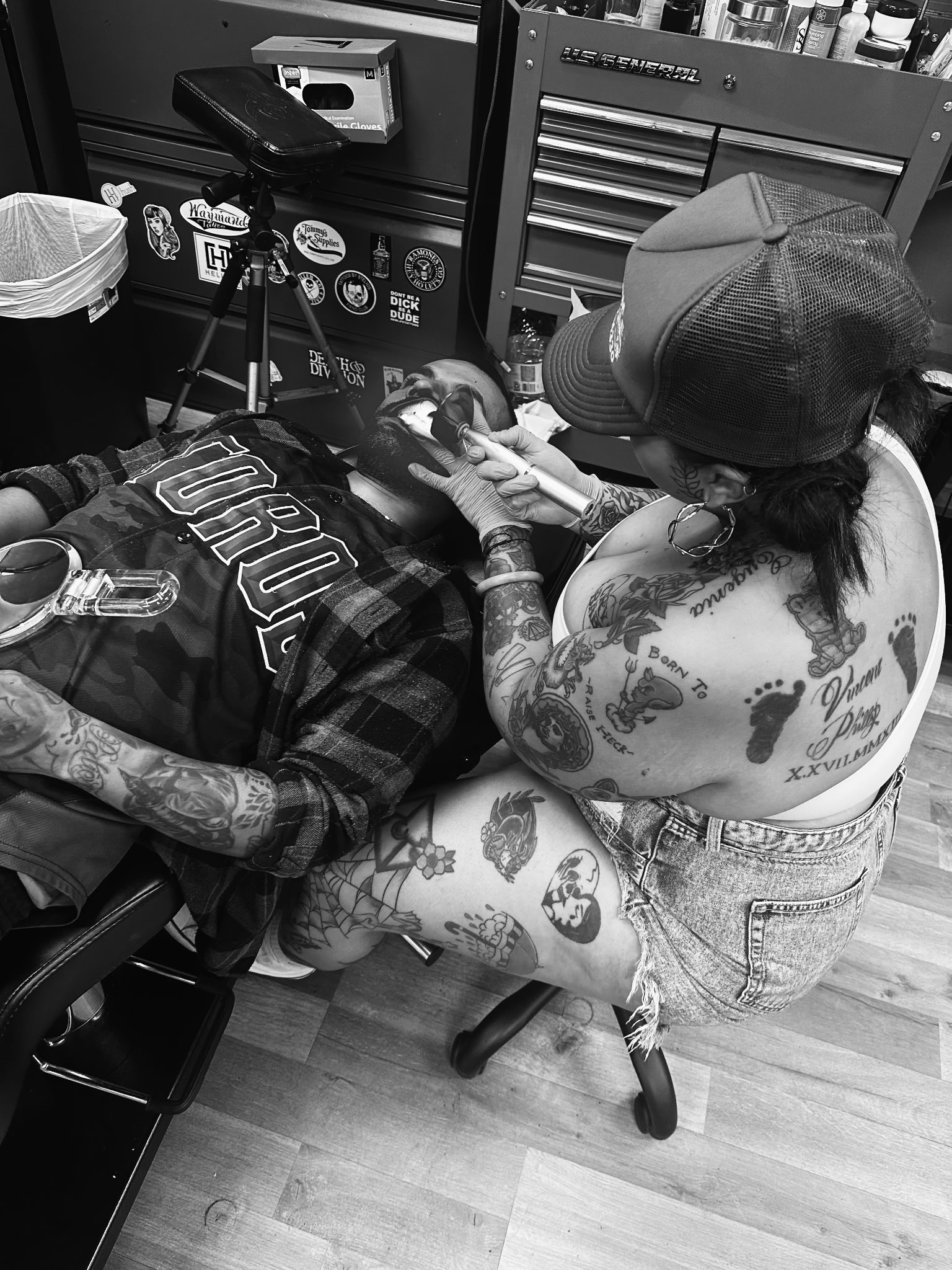 Kiyana KiyKiy Broussard piercing a client at Darkstar Tattoo Riverside CA