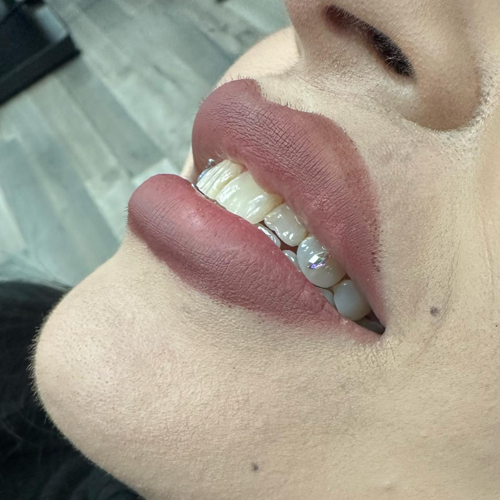 Close up tooth gem on lower teeth at Darkstar Tattoo Riverside CA
