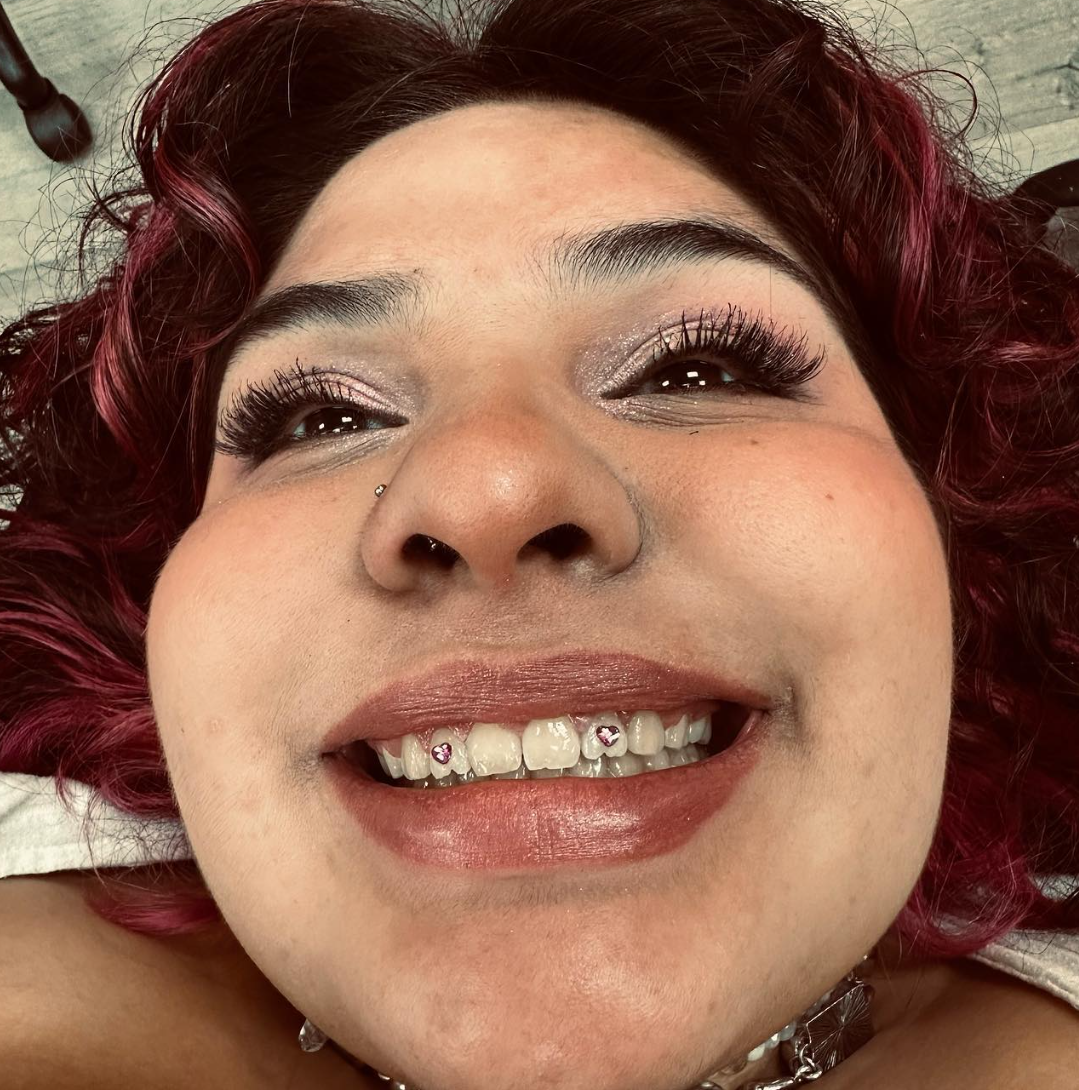 Tooth gem result smiling client at Darkstar Tattoo Riverside CA