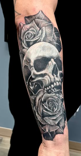 Neo traditional black and grey skull and roses forearm tattoo at Darkstar Tattoo Riverside CA