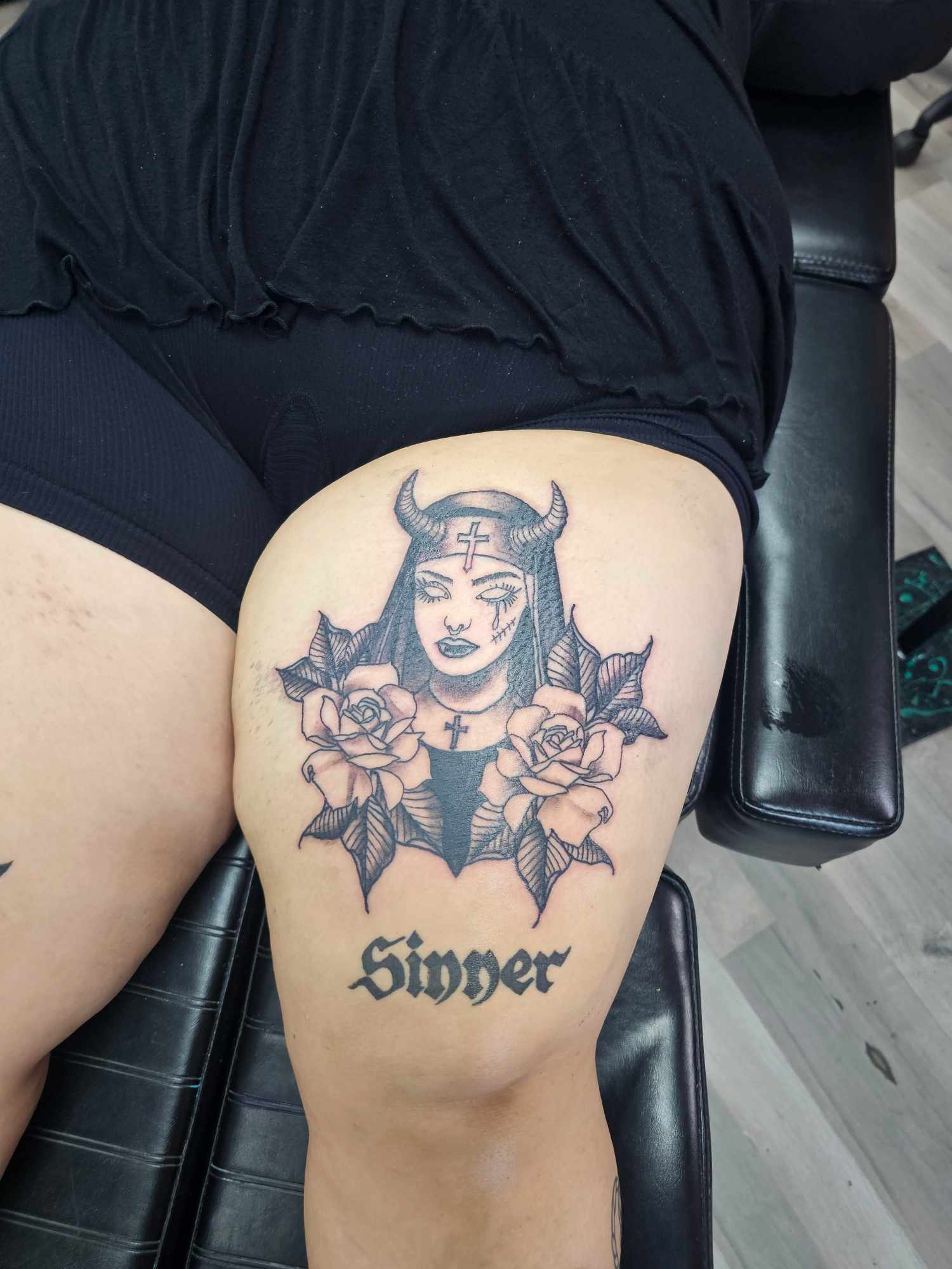 Black and grey sinner nun thigh tattoo at Darkstar Tattoo Riverside CA